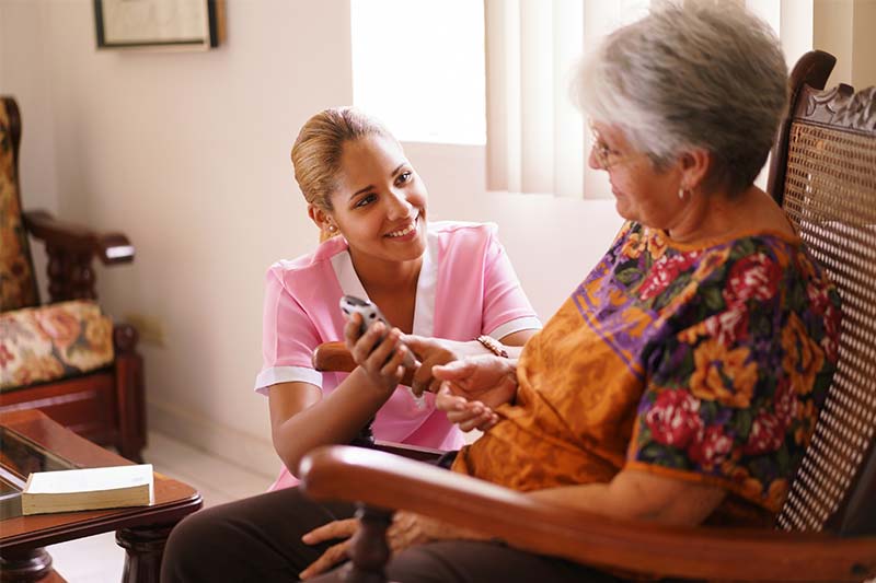 Aide Helps Elderly Woman