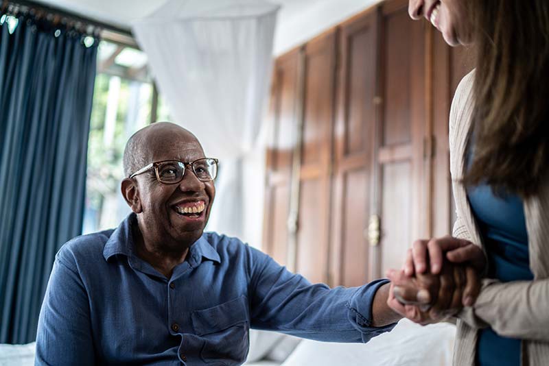 Home caregiver talking to patient at home