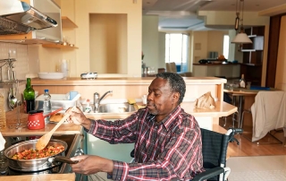Senior Man Cooking a Dinner with Home Health Care Services