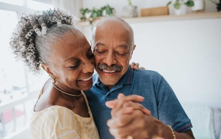 senior couple dancing in the living room