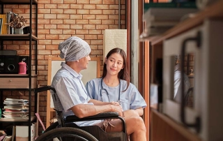 Cancer elderly patients in wheelchairs receive rehabilitation treatment in private home