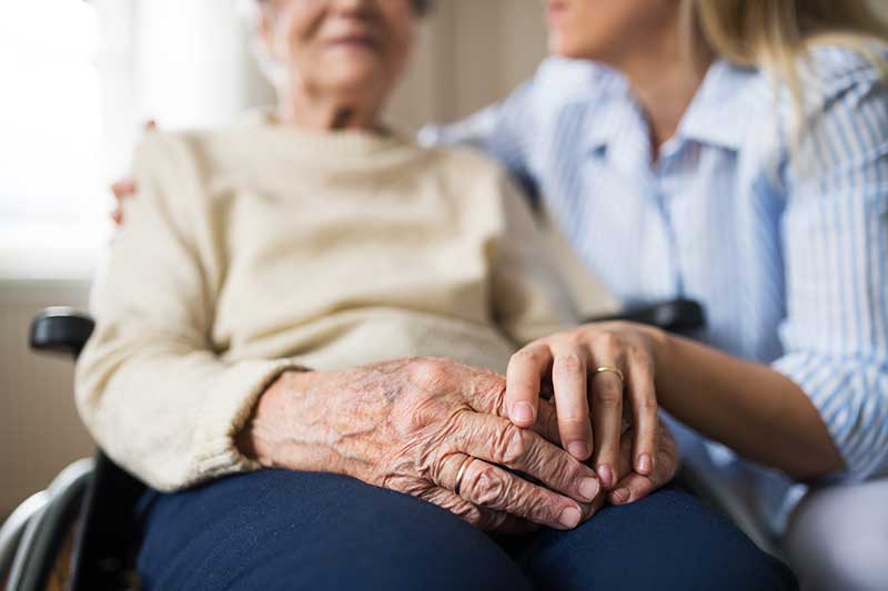 Senior woman in wheelchair getting help with the cdpap program at home