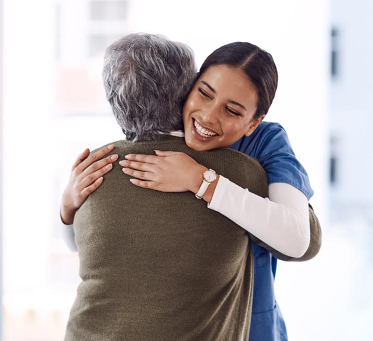 Caregiver embracing patient