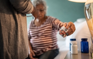 Senior woman taking medicines at home